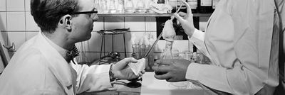 Two workers carton testing in a lab