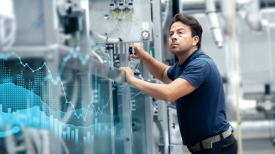 Chart and man in front of machine