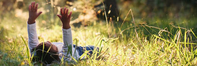Child laying on the grass playing