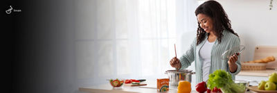 Woman cooking, soup in Tetra Recart carton package