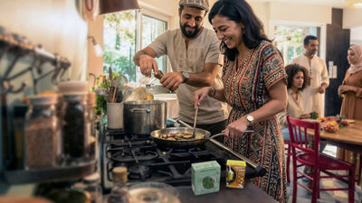 Couple in kitchen cooking