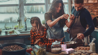 Family cooking dish with beans