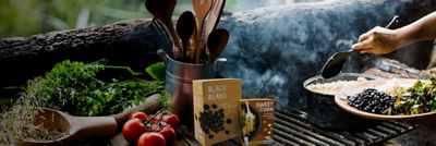 Cooking dish with beans and vegetables on grill