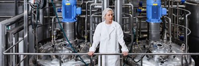 Femme dans une usine de production de cottage cheese.