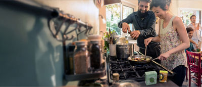 Couple in kitchen cooking