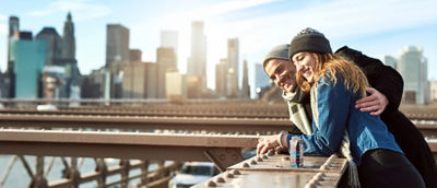 Young man playing with little girl, juice in Tetra Prisma Aseptic carton 