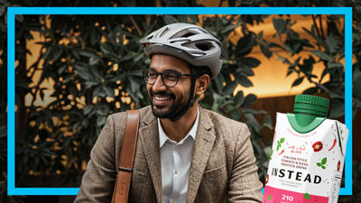 Young man with headphones and mobile phone, protein drink in Tetra Prisma Aseptic carton