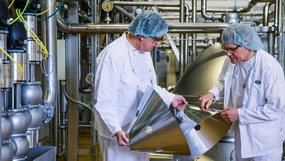 Food engineers examines separator discs, Arla Food