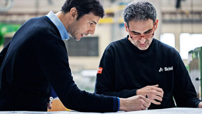 Sidel engineers looking at drawing