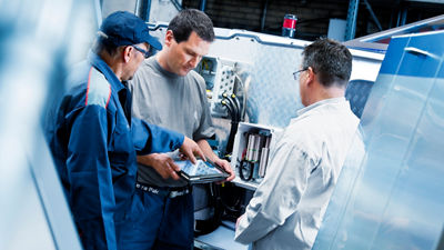 Engineers working and looking at a tablet