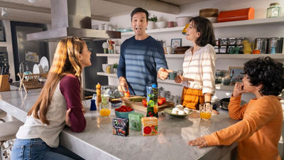 family of four sharing food in the kitchen