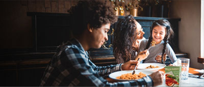 Family having dinner eating pasta