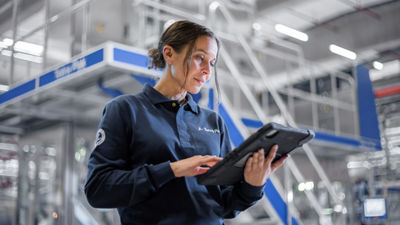 Female service engineer with tablet at production site