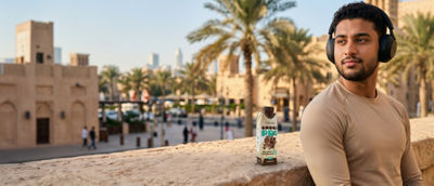 Man exercising on bridge, protein drink in Tetra Prisma Aseptic carton