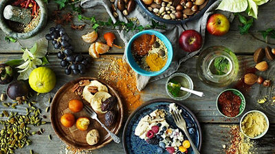 Different kinds of food, dessert & spices laid out on a table