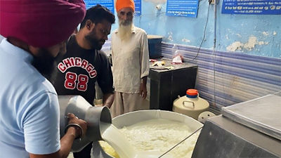 Handling fresh milk at farm in India.
