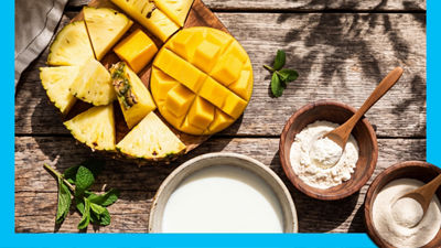 Fresh pineapple and mango, yoghurt in bowl and protein powder