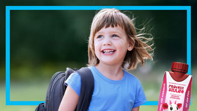 Young girl with backpack, protein drink in Tetra Prisma Aseptic carton 