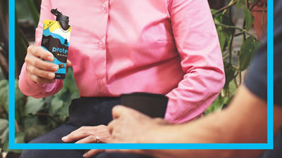 Woman holding protein drink