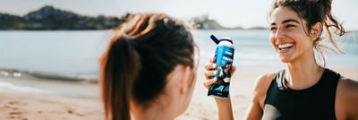 Sports women with protein drink in Tetra Prisma Aseptic carton