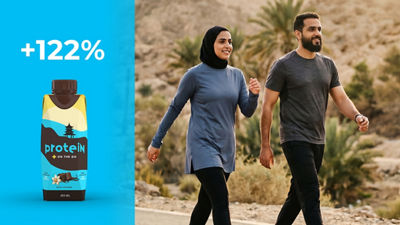 Young couple power walking, protein drink in Tetra Prisma Aseptic carton