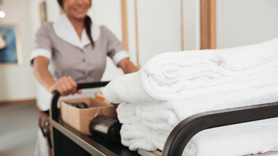 Hotel maid pushing cart