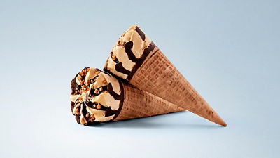 Decorated waffle cone filled with ice cream and chocolate topping
