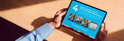 Hands holding tablet with bite-sized brochure. 