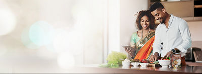 Couple in kitchen preparing food