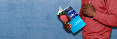 Person holding and reading a Tetra Pak case study about juice producer Jumex