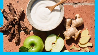 Ashwagandha root, yoghurt in bowl, fresh apples and ginger