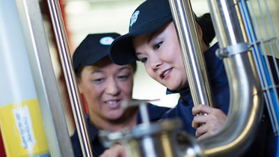 Factory workers performing maintenance