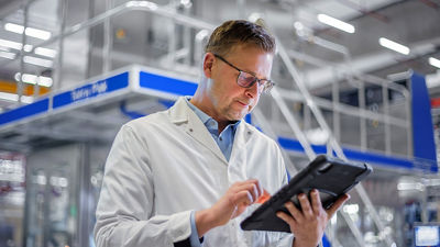 man looking at tablet in factory