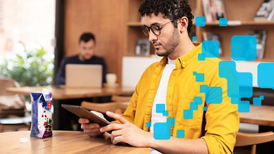 Man with tablet, scanning QR code on carton package
