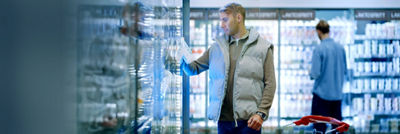 Man in grocery store shopping chilled beverages