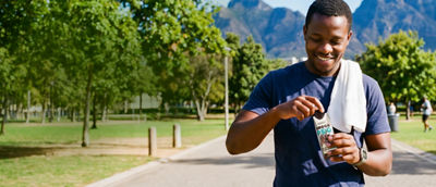 Happy man holding protein drink in Tetra Prisma Aseptic carton