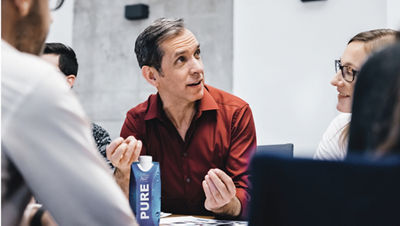 Man in meeting talking about carton product