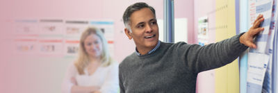 man pointing at a board
