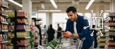 Bir markette cep telefonuyla bir adam