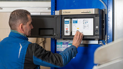 Man in front of control panel, milk cell analysis