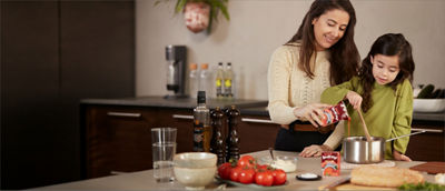 Mother and child cooking, ready meals in Tetra Recart cartons