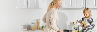 Mother and child in kitchen cooking