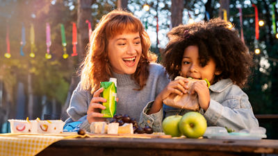 Mother and child eating sandwiches