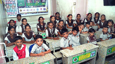 Students with desks made of recycled beverage cartons