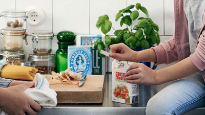 People by the table with variety of food packages