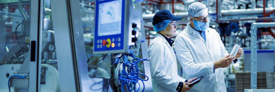 Tetra Pak operator and customer examining carton package