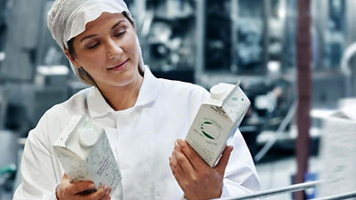 Female operator with Tetra Rex carton packages