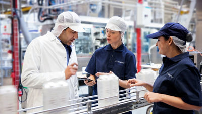 Customer and operators inspecting carton packages