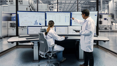 Operators analyzing data on large screens, Tetra Pak Factory OS