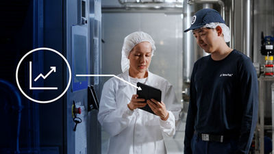 People at production site looking at tablet